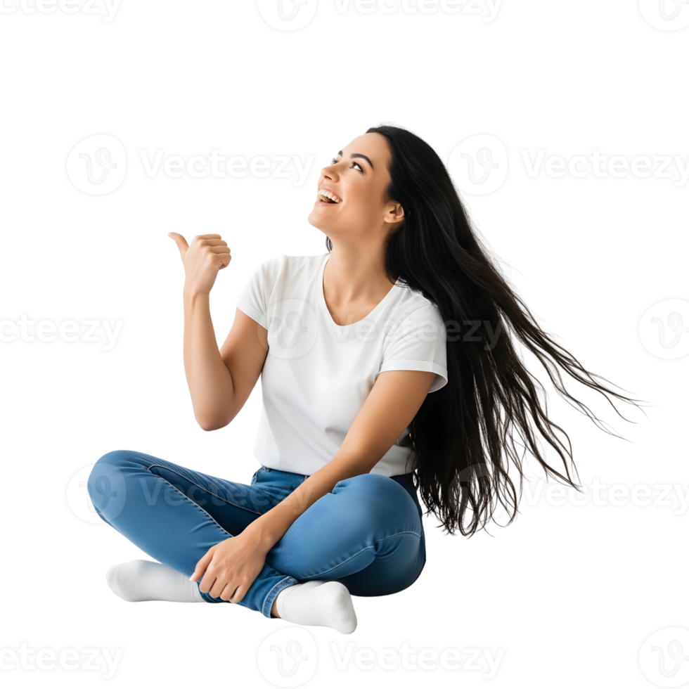 A cheerful young woman with long black hair is sitting crosslegged and pointing upwards, isolated on transparent background png