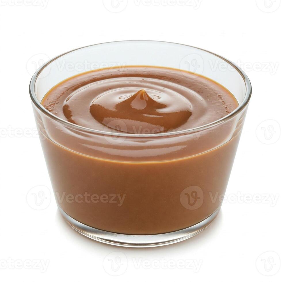 A glass bowl filled with caramel sauce photo