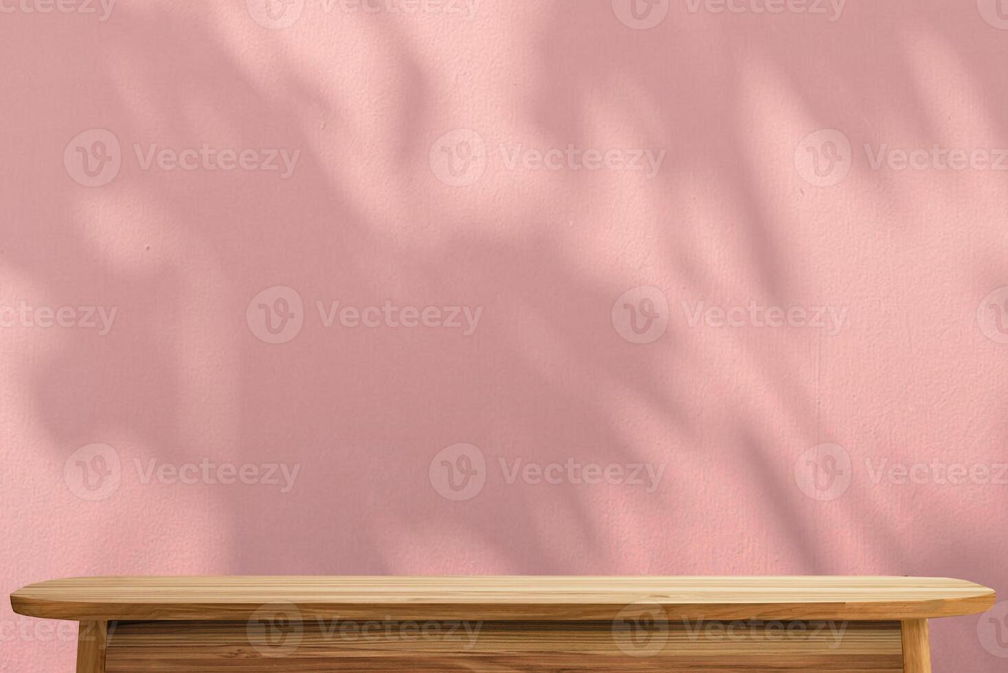 Pink Wall with Wooden Table and Palm Leaf Shadow photo