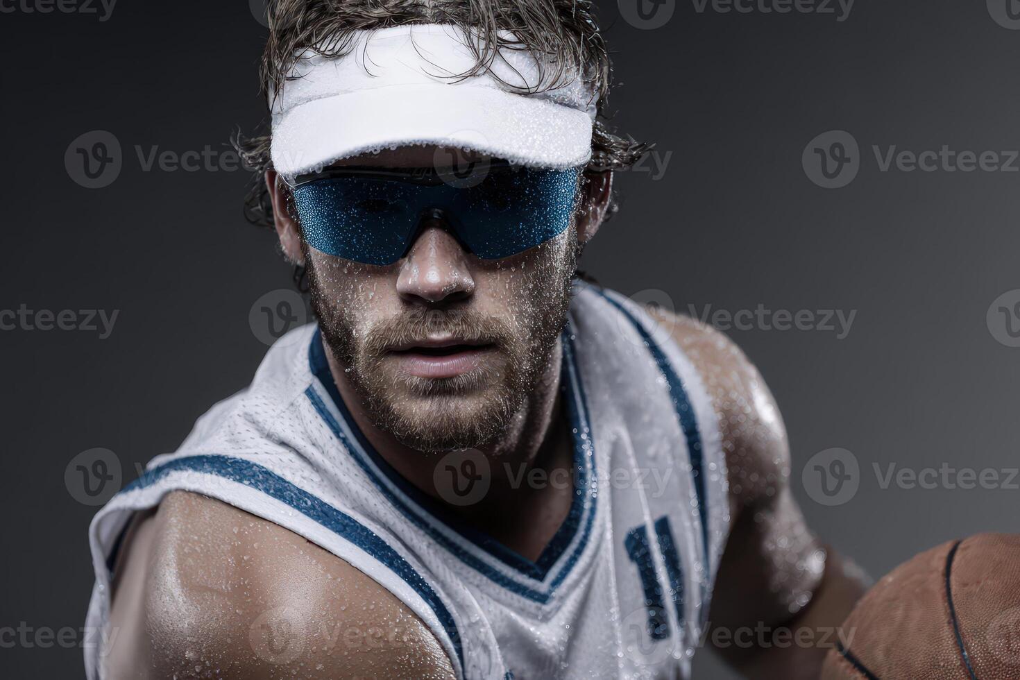 Sweaty basketball player with visor holds ball photo