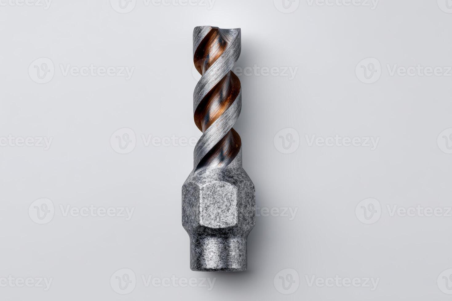 Metal drill bit with spiral flutes on a white background photo