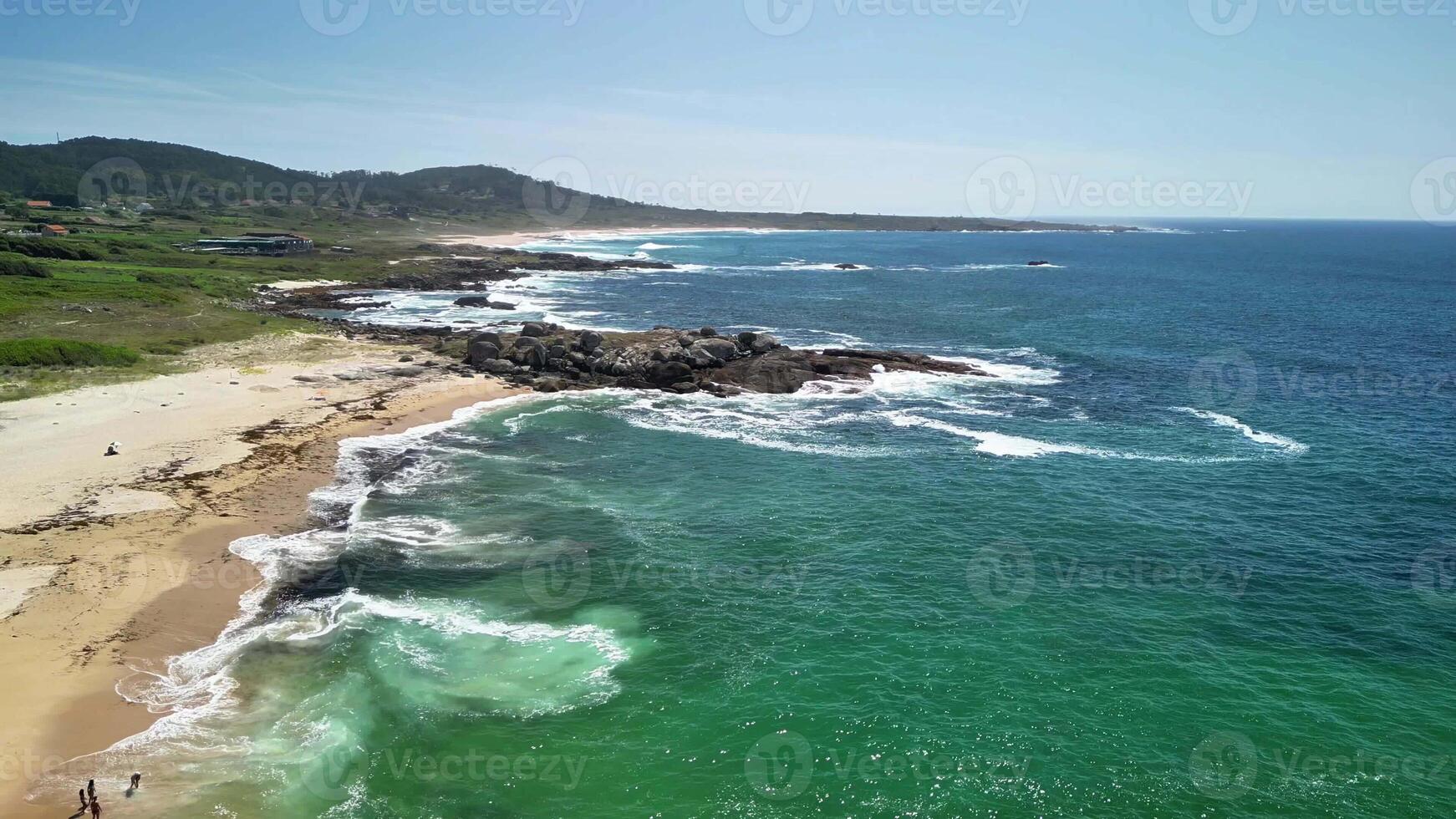 Discover the tranquil beauty and peaceful charm of this serene beach featuring gentle waves and lush vibrant greenery photo