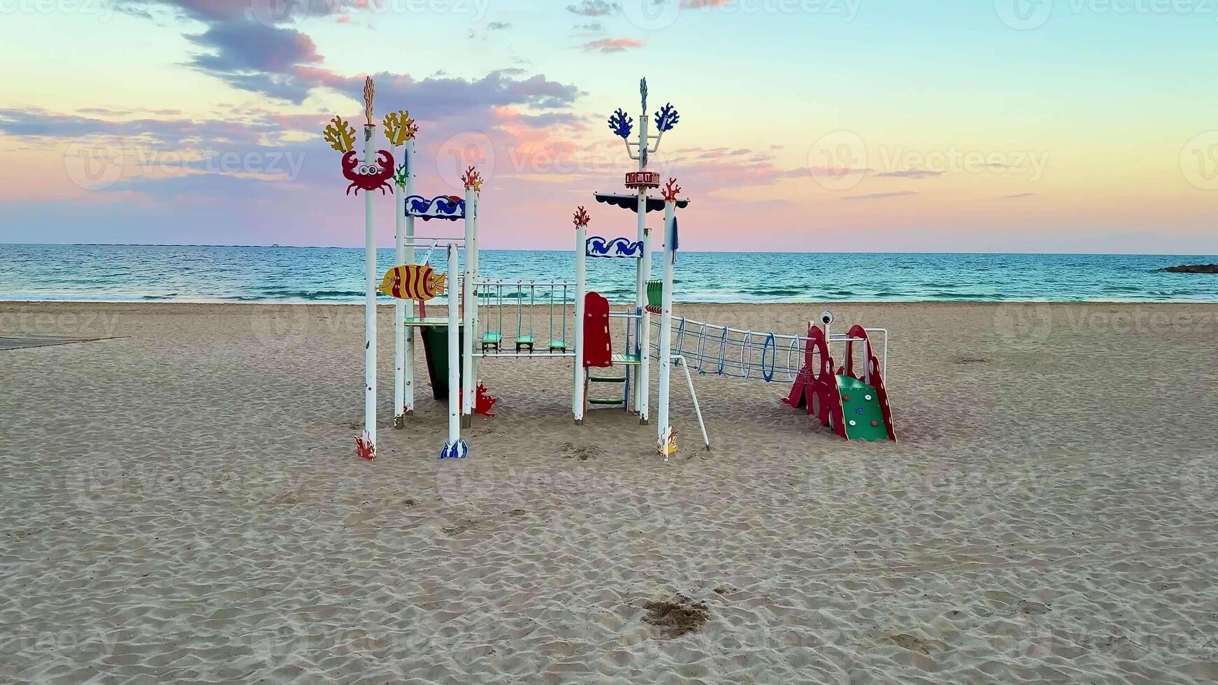 A vibrant and lively beach playground showcasing imaginative designs, all set against a breathtaking sunset backdrop photo