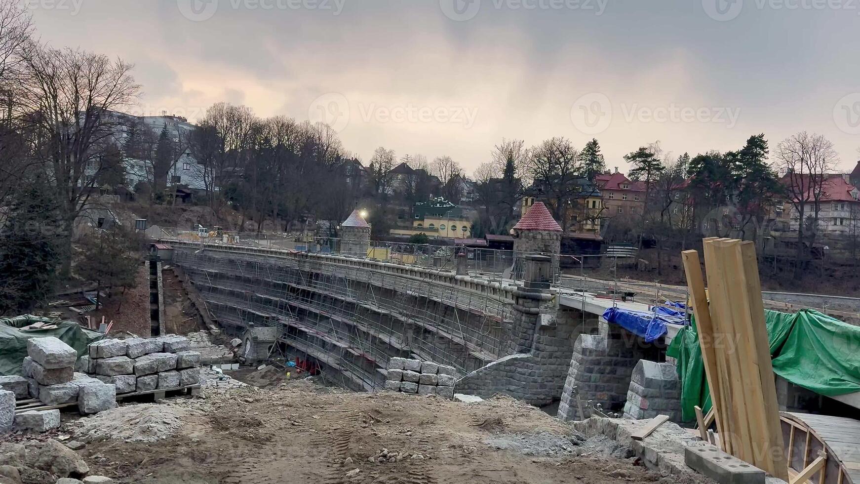 An active urban construction site displaying stone structures and a variety of materials for a new developing project photo