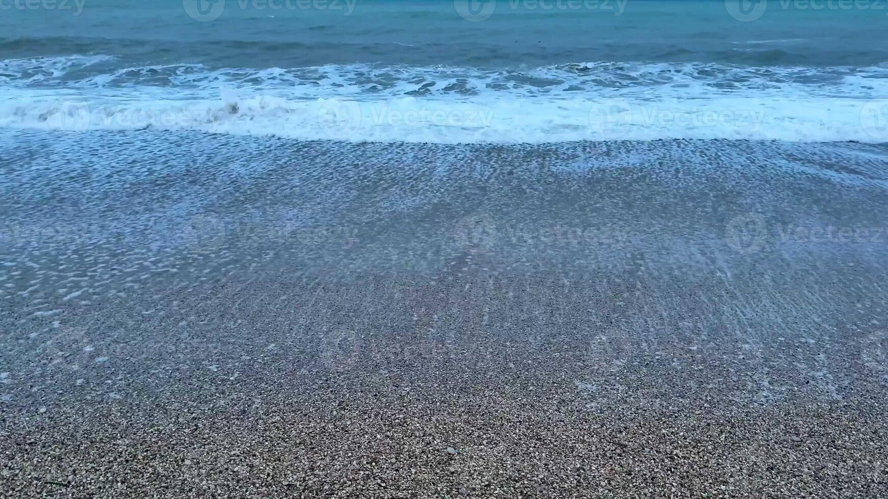 Immerse yourself in the serene and calming beauty of gentle waves softly lapping at the shore at twilight photo