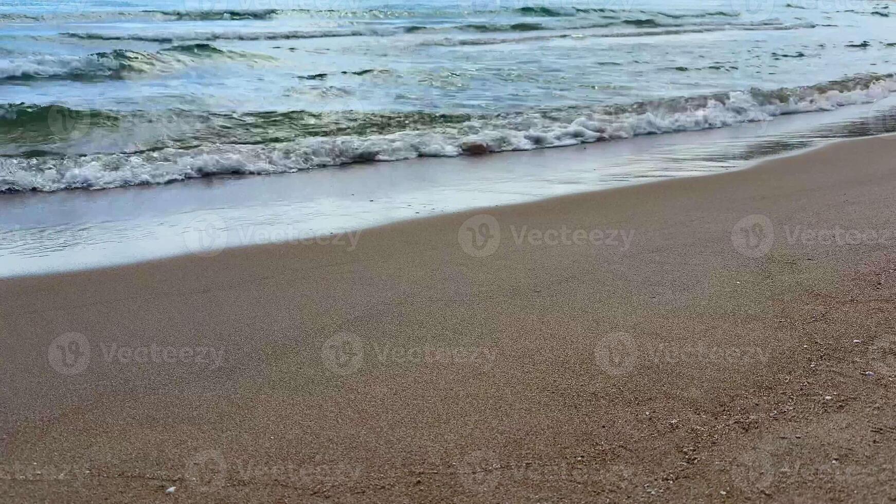 A serene calm beach scene featuring soft golden sand and gentle ocean waves, ideal for unwinding and relaxation photo