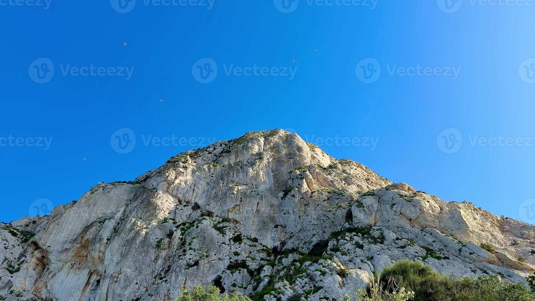 Enjoy the breathtaking and extraordinary view of a rocky mountain landscape set against a clear blue sky photo