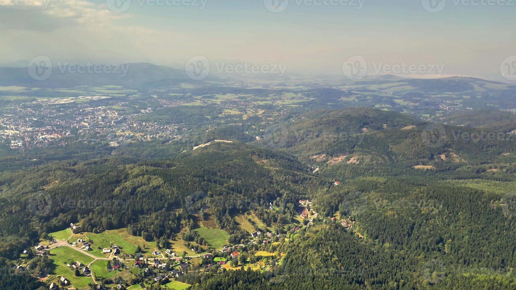 A breathtaking aerial image beautifully showcasing serene valleys along with vibrant greenery surrounding them photo