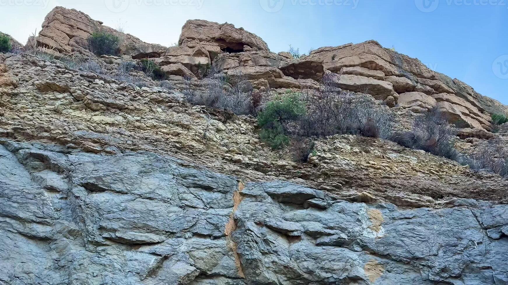 Discover a breathtaking rocky tunnel surrounded by a mesmerizing landscape that invites you to adventure photo