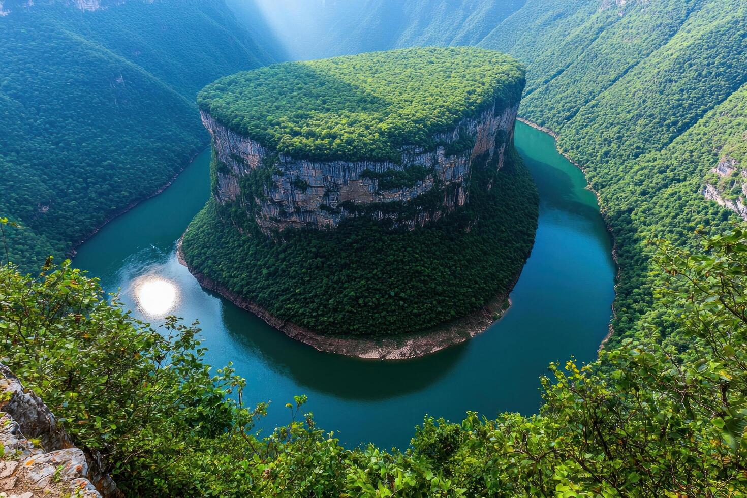 a large green mountain with a river in the middle photo