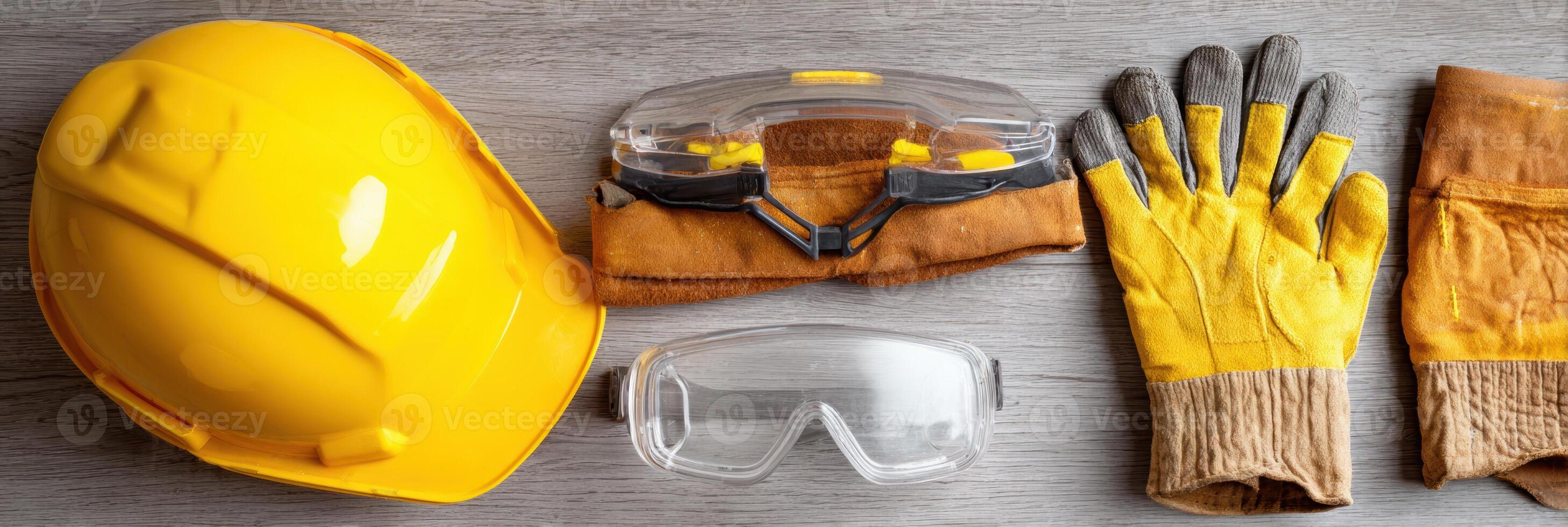 Safety Gear Flat Lay Featuring Hard Hat, Safety Gloves, and Goggles on a Neutral Backdrop Suitable for Construction and Industrial Activities photo