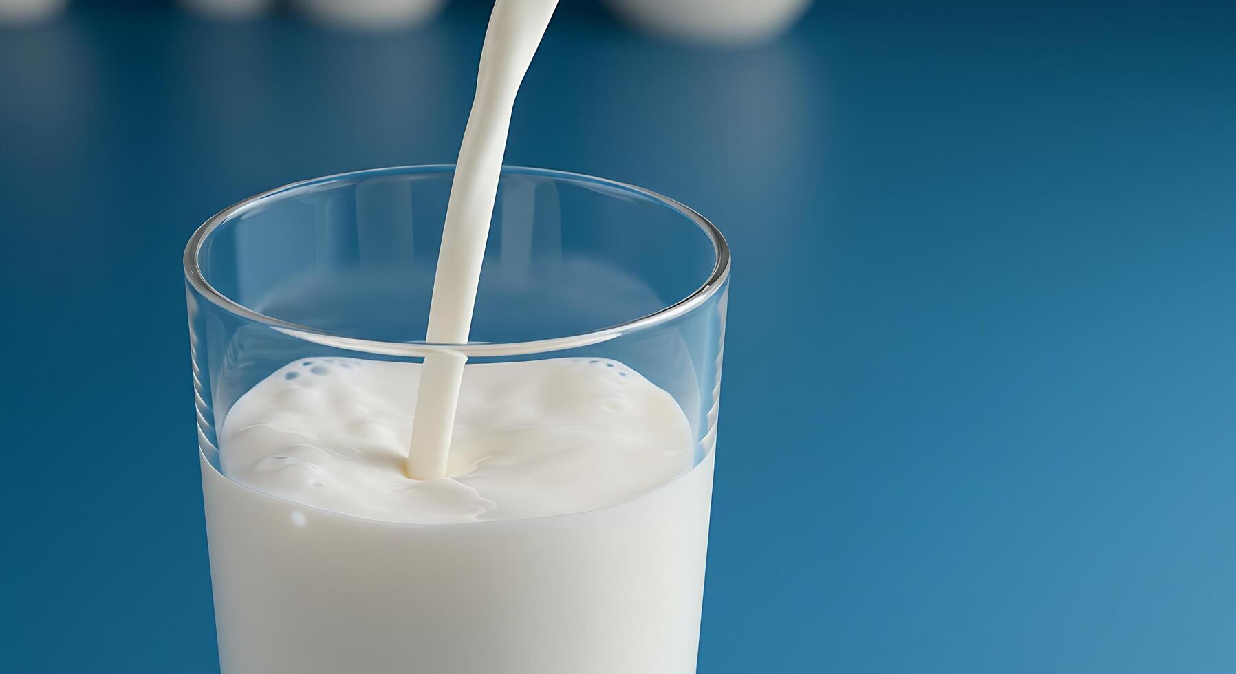 Milk Pouring into Glass on Blue Background Fresh Dairy Product Photography photo
