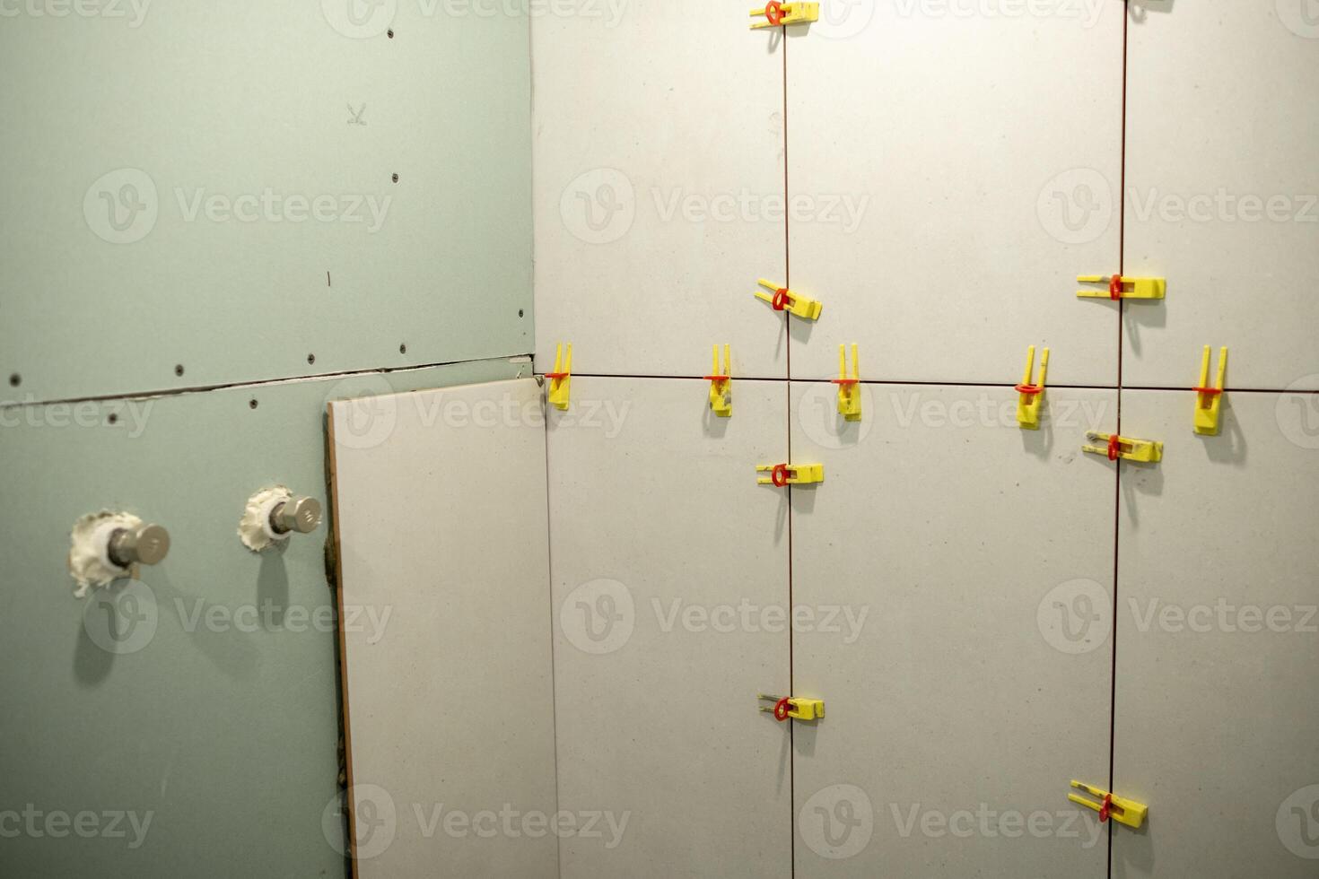 Wall Renovation Project in Progress With Clamps Securing Panels Together in a Construction Space photo