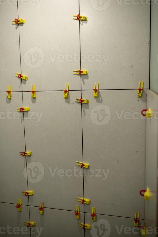 Wall Installation With Tile Spacers in a Modern Setting During a Renovation Project photo