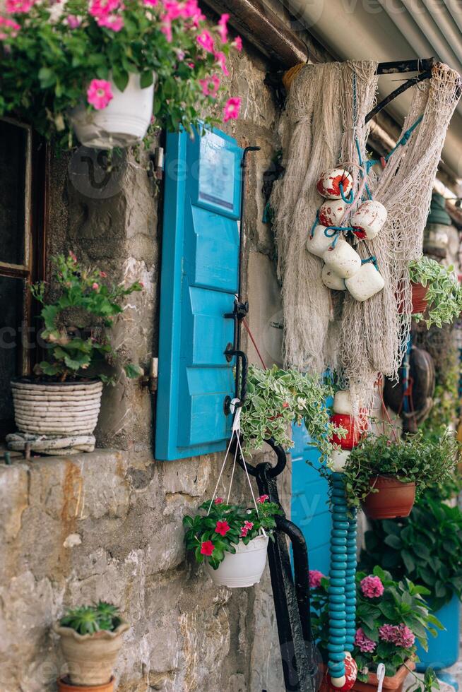Close up of beautiful old window with flowers in a pot in old town Przno by the sea, Montenegro. photo