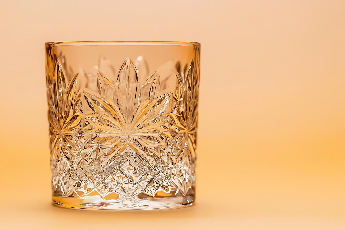 Elegant Cut Glass Tumbler on Warm Background. Perfect for Drinks or Still Life Photography. photo