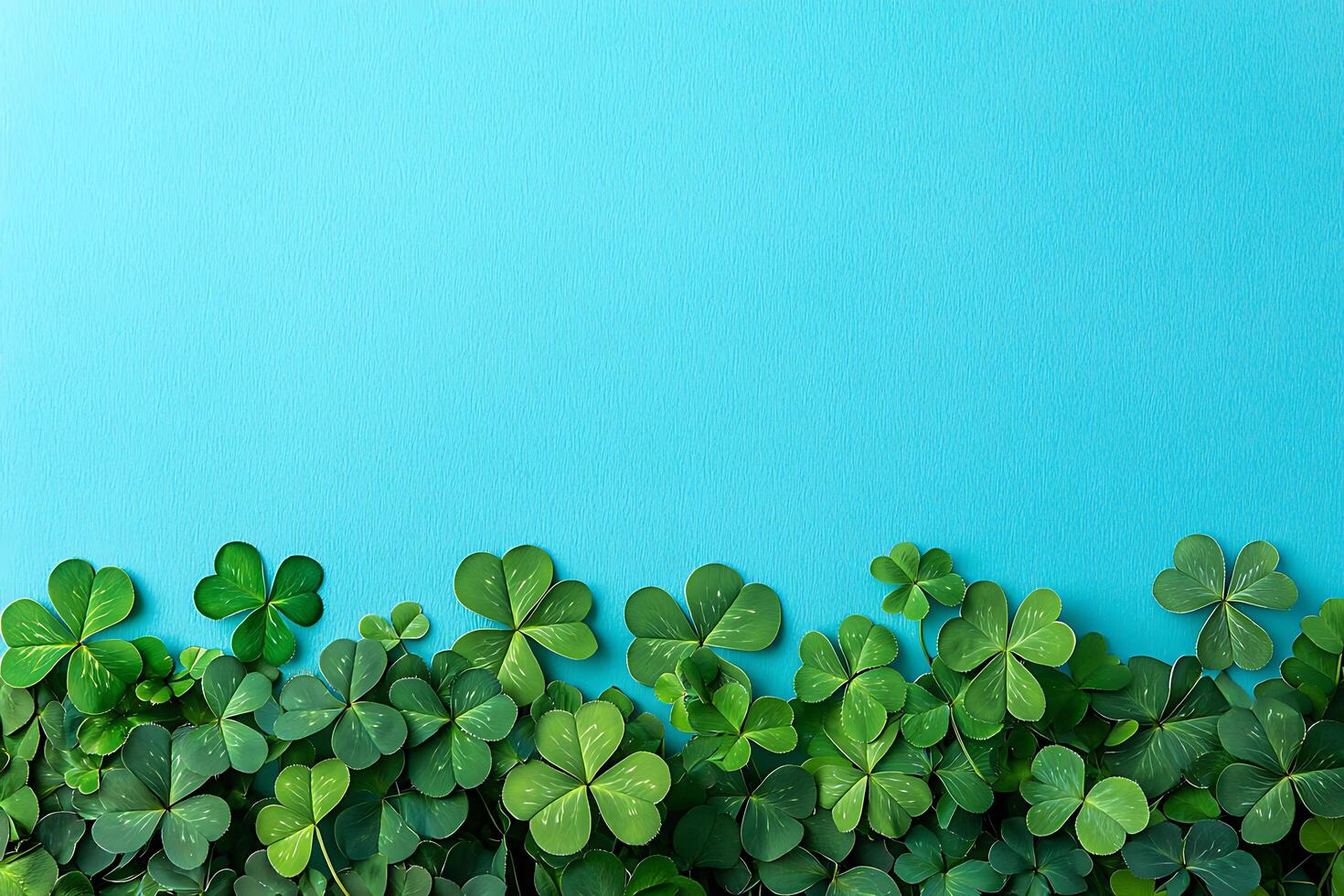 Vibrant Green Clover Leaf Border on a Bright Blue Background. A festive and cheerful image perfect for St. Patrick's Day or spring designs. photo