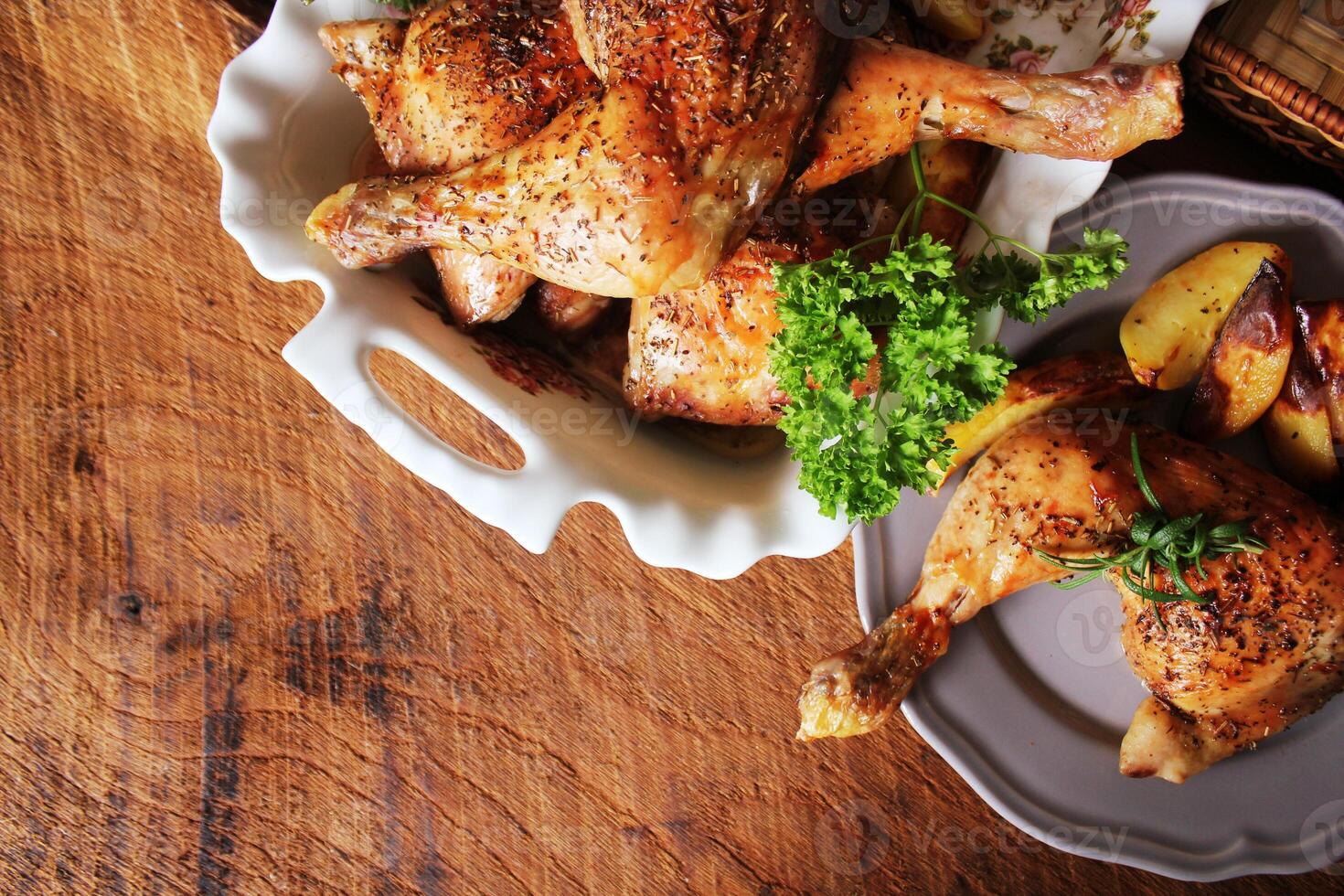Grilled chicken leg with potato for garnish. Top view. Wooden background. photo