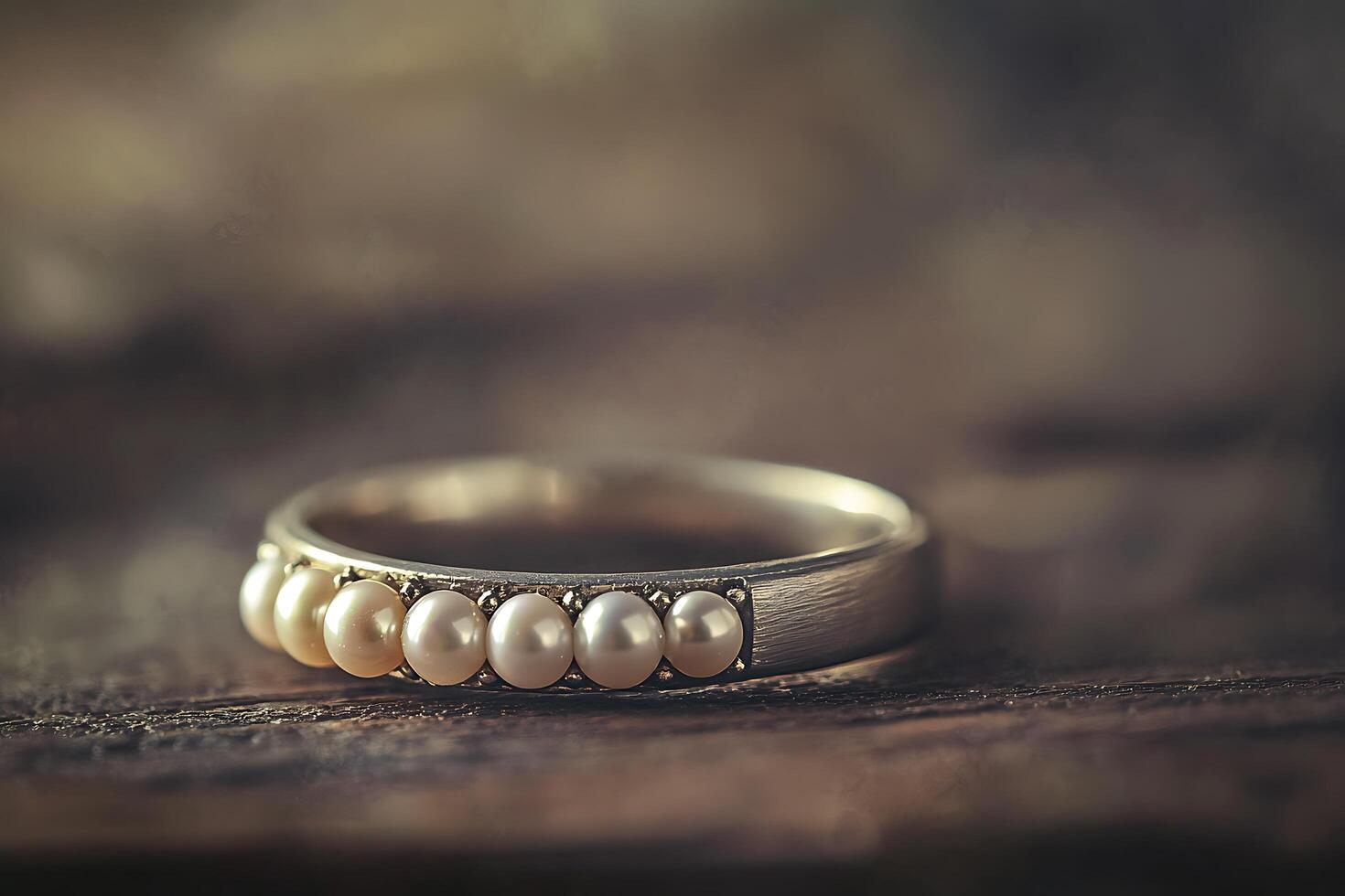 Elegant Pearl and Silver Ring on Rustic Wooden Surface. A close-up shot showcasing the delicate detail of a beautiful pearl ring. photo