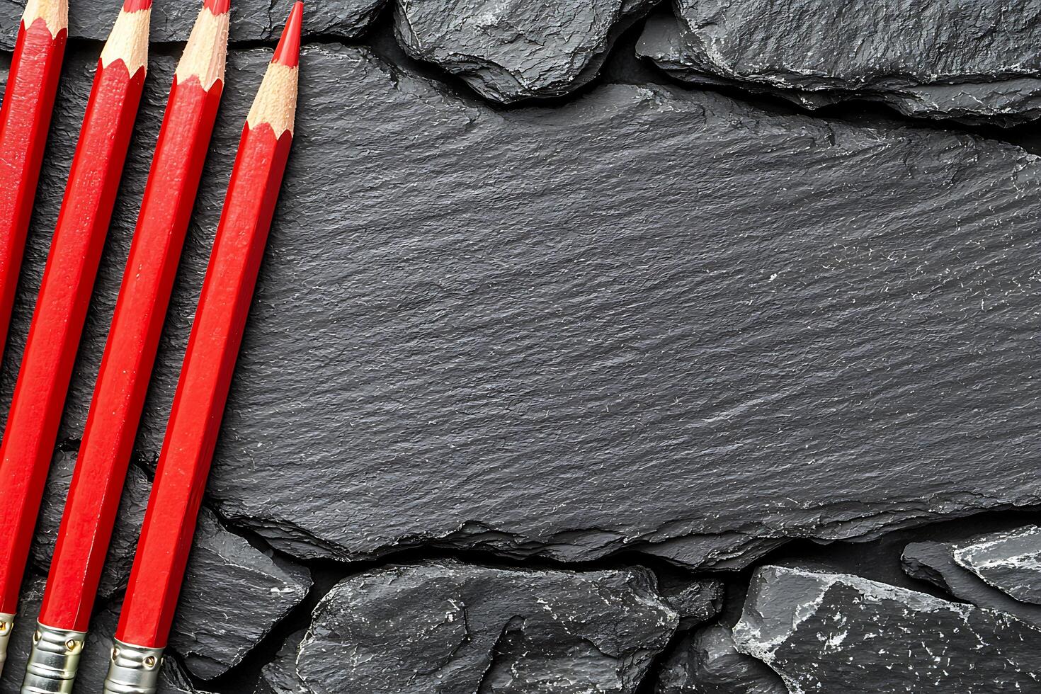 Red Pencils on Dark Slate Background Copy Space for Text or Design. photo