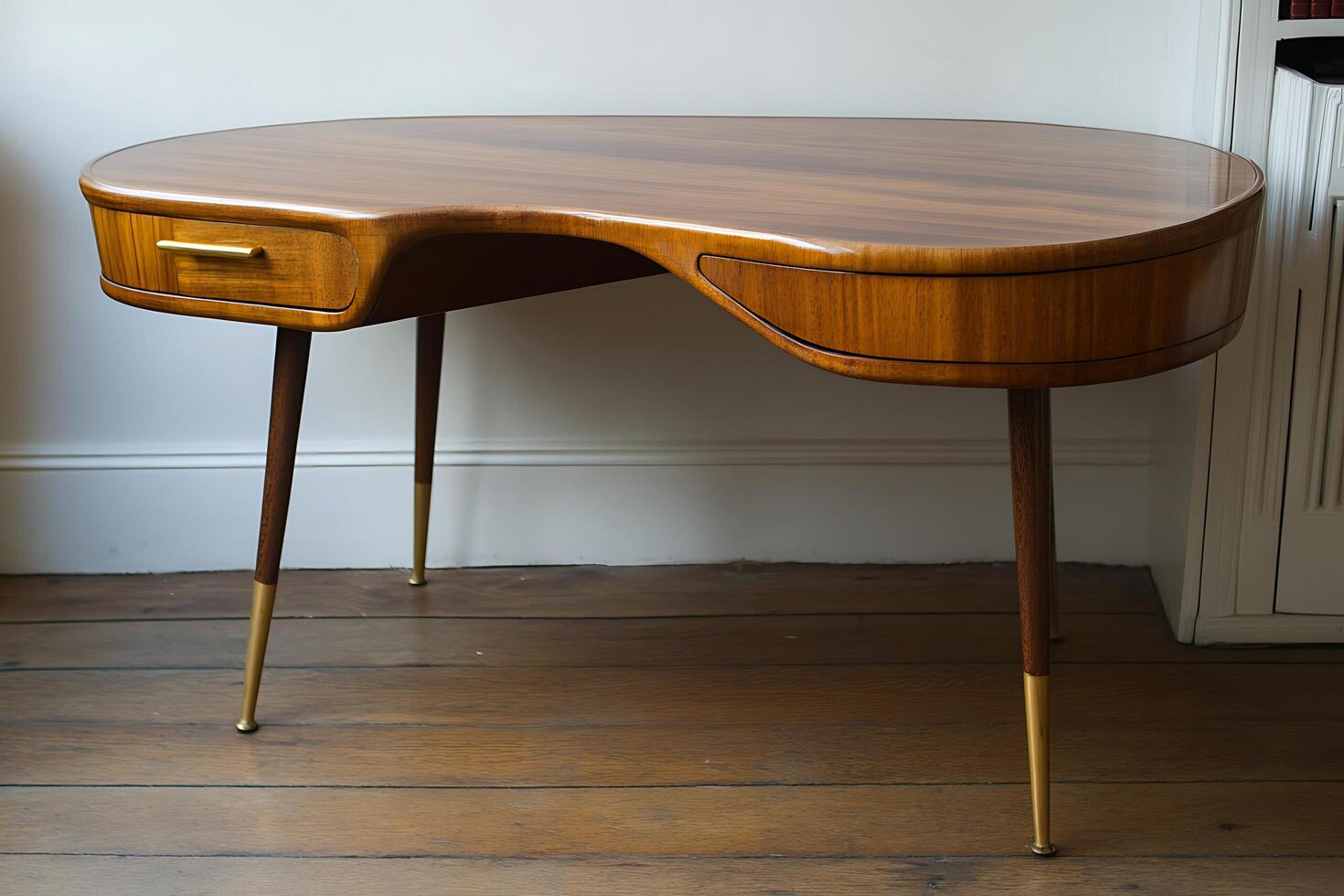 Mid-Century Modern Kidney-Shaped Desk with Brass Legs. A stylish and functional writing desk perfect for home office or studio. photo