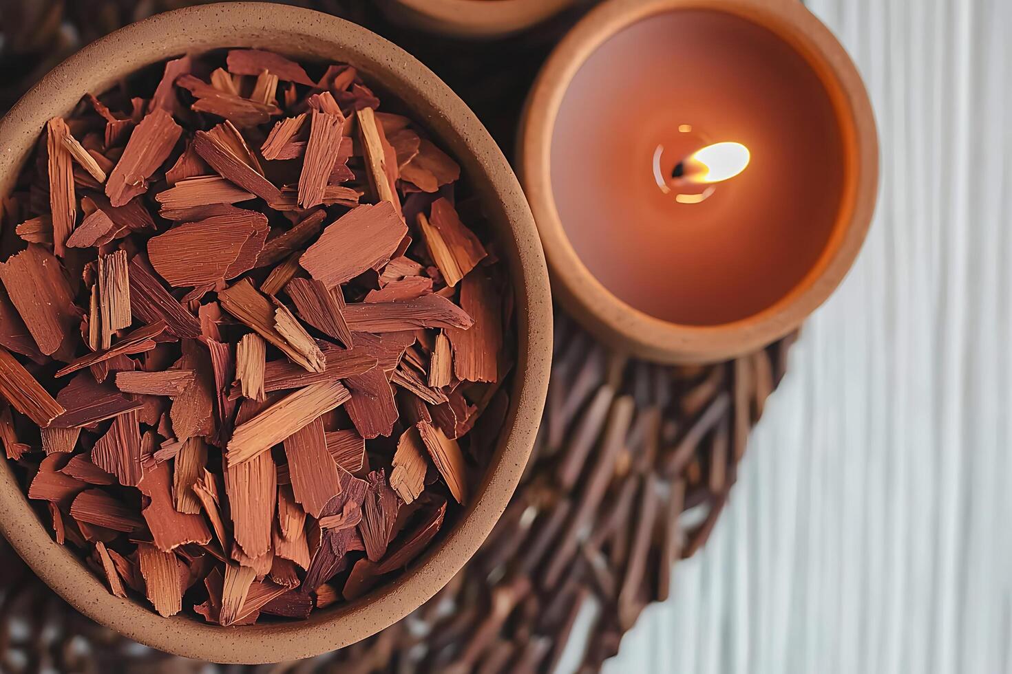 Aromatic Wood Chips in a Clay Bowl with a Lit Candle Spa and Wellness Concept. photo