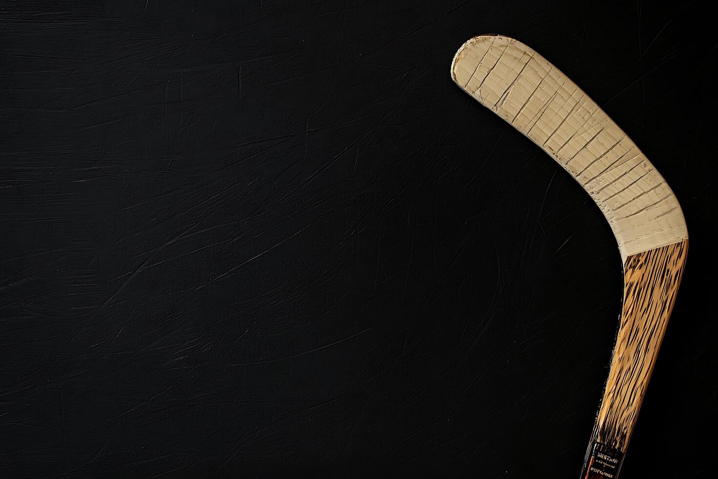 Worn Wooden Ice Hockey Stick on Black Background Copy Space. photo