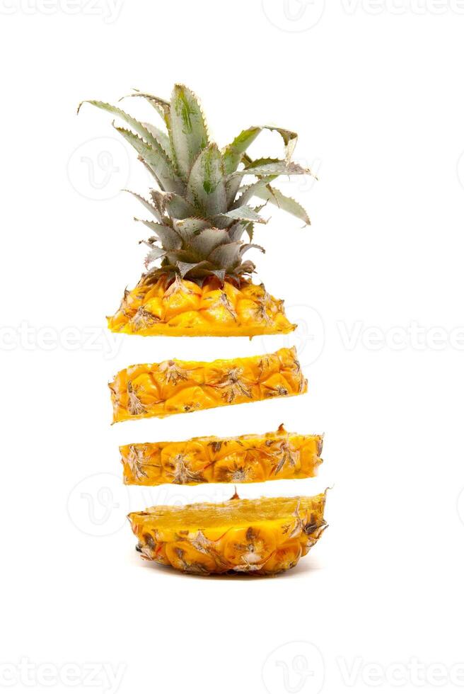 ripe delicious baby pineapple slices floating on white background photo