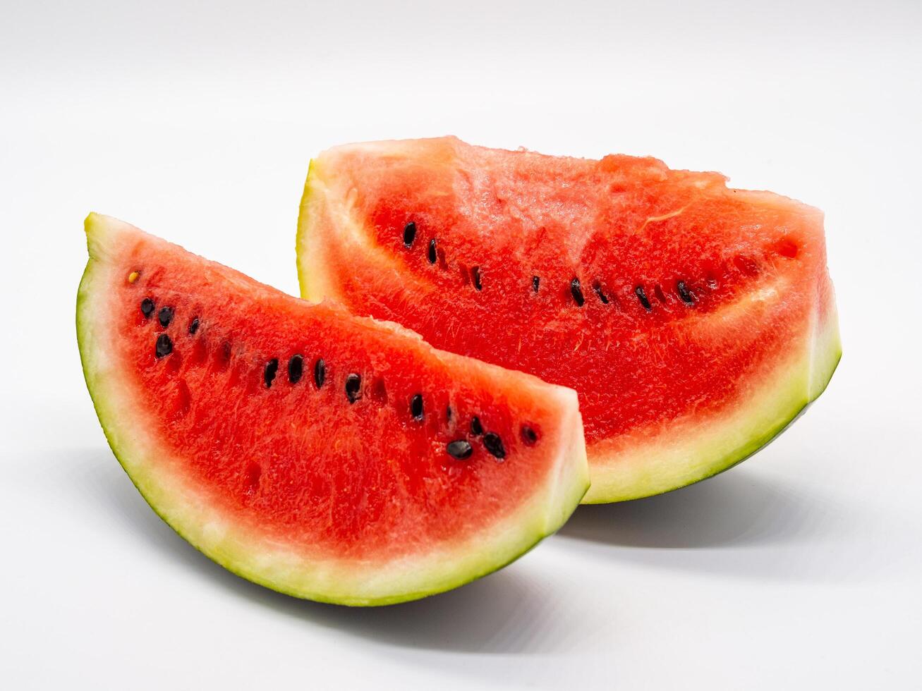 Two slices of watermelon are shown on a white background photo