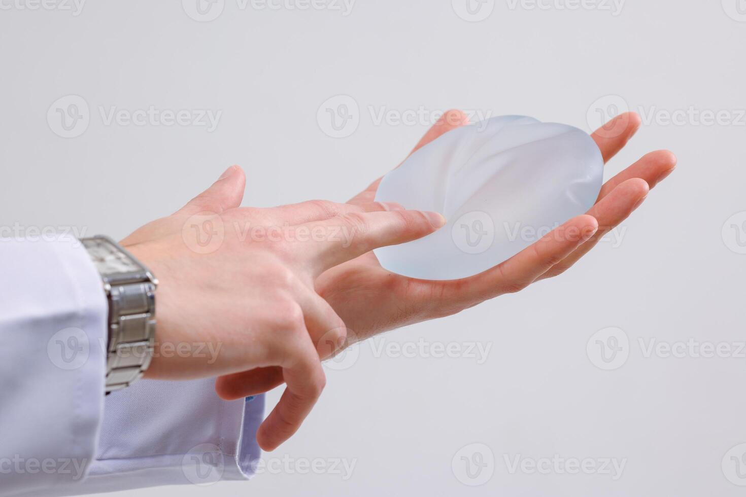 Plastic Surgeon Demonstrates Silicone Breast Implant Mammoplasty and Augmentation Consultation photo