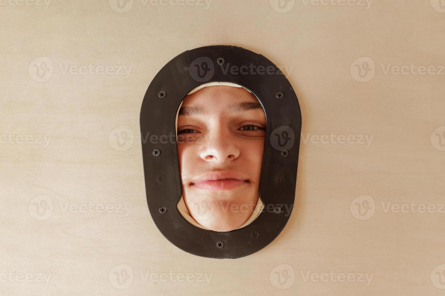 Portrait of a Smiling Client in Massage Table Face Hole at Rehabilitation or Wellness Therapy Session photo