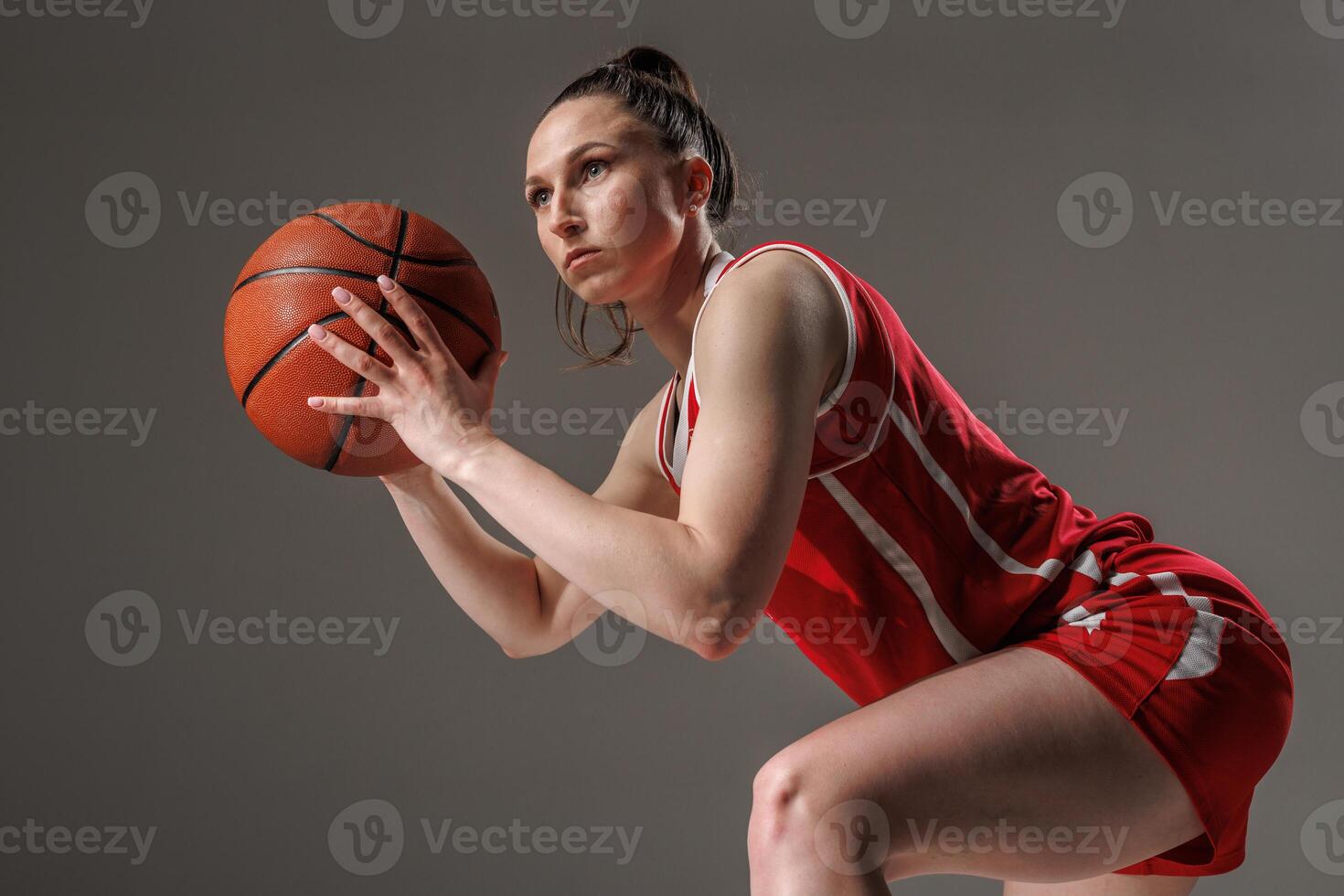 Focused Female Basketball Player in Action, Preparing to Shoot during Professional Training photo