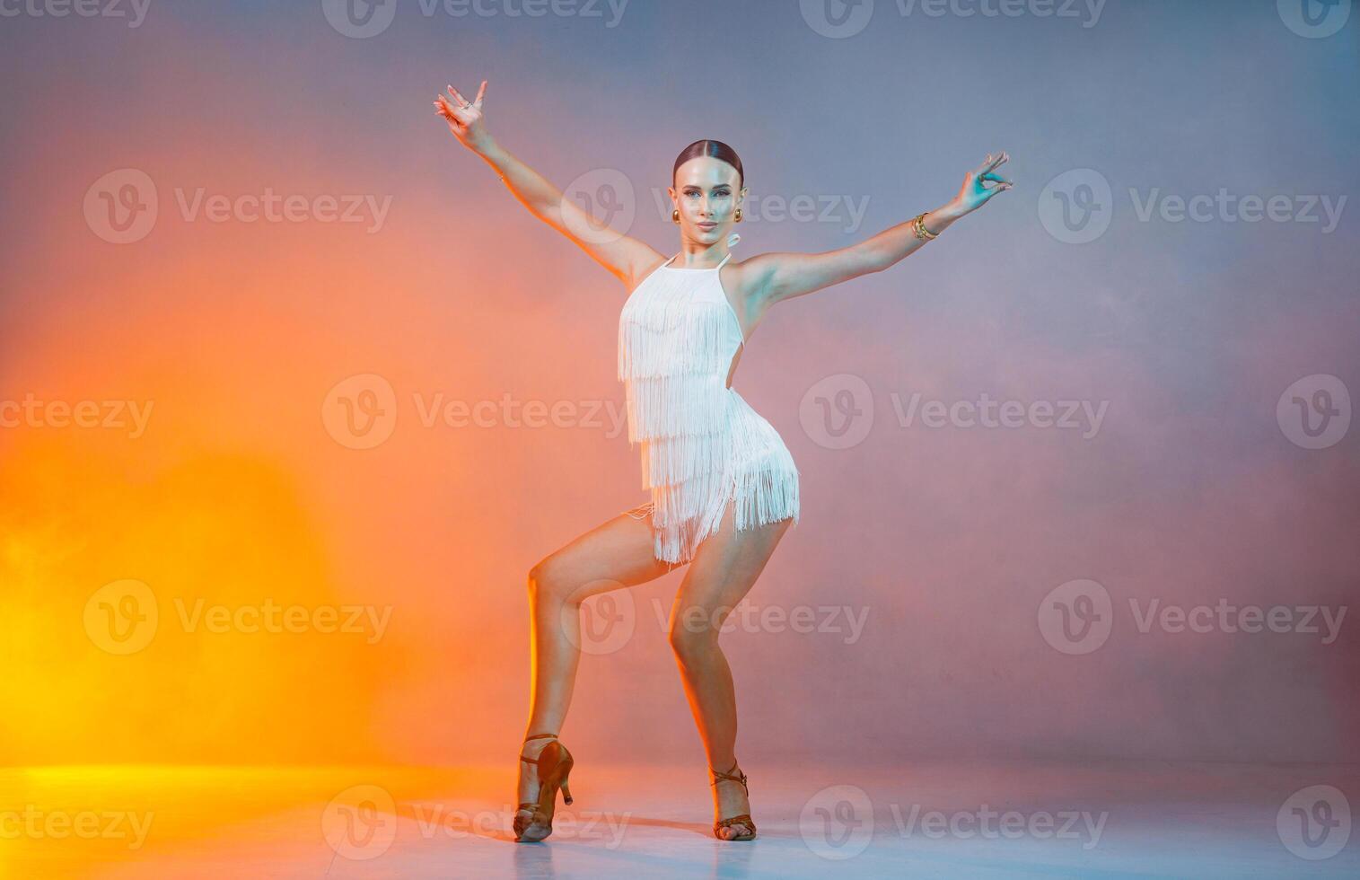 Latin Dance Woman in White Fringe Dress Striking Dynamic Salsa Pose Studio Performance Portrait photo