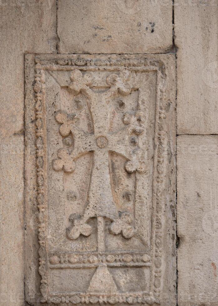 Stone wall with carved pattern in ancient temple, Geghard, Armenia photo