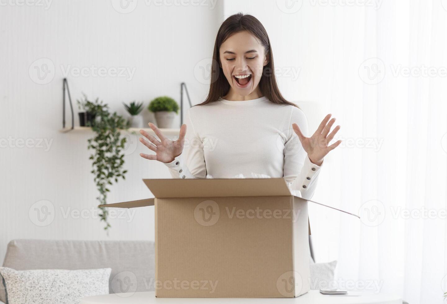 Positive client satisfied when open cardboard box parcel with fashion clothes, shopping online concept photo