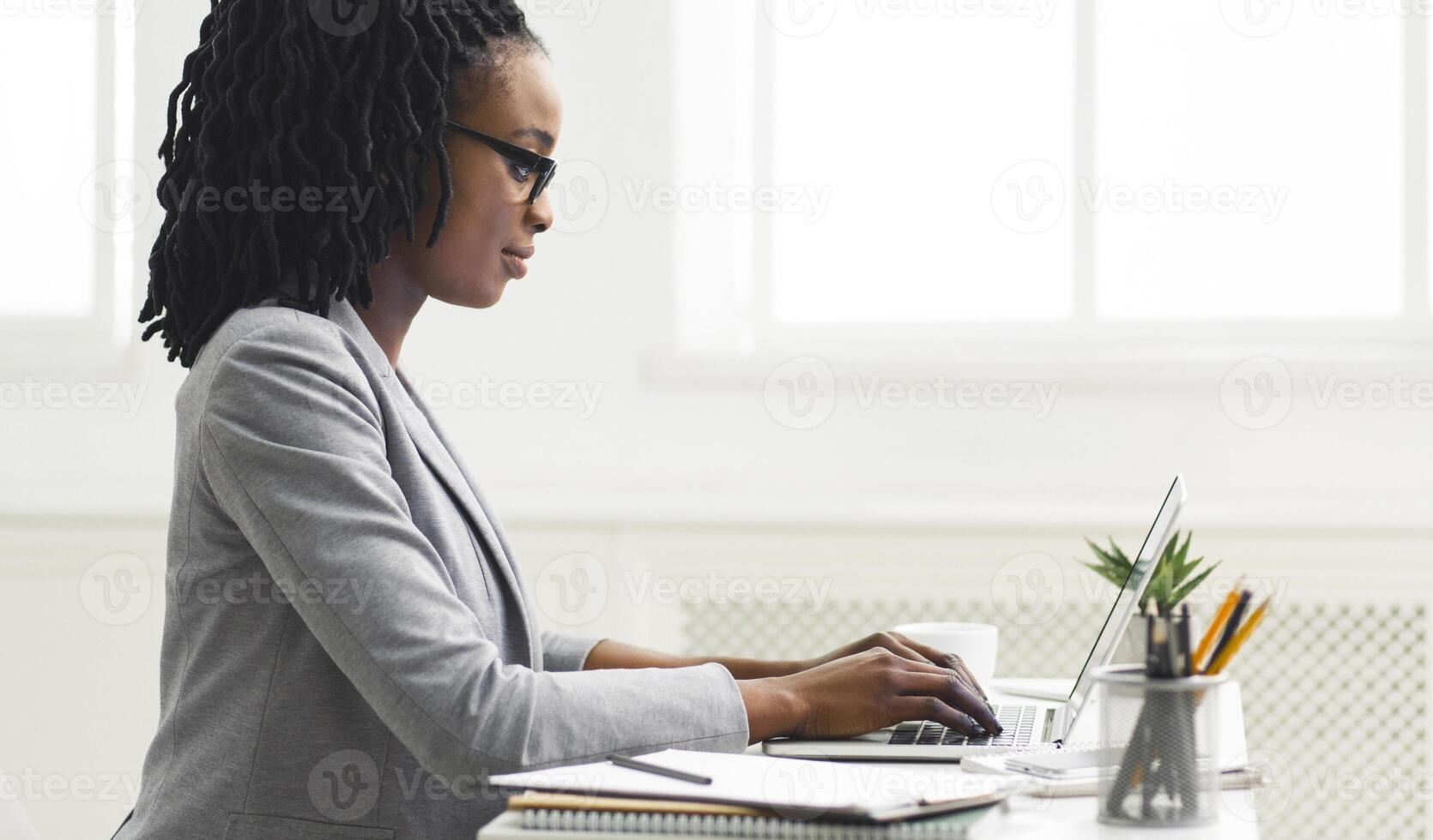 Office Work. Black Girl Using Laptop Computer At Workplace. Copy Space, Side View photo