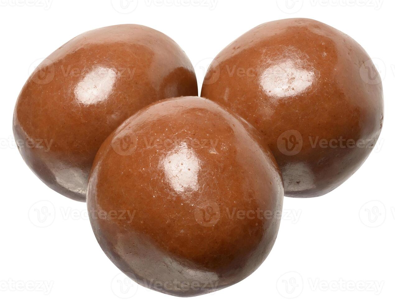 Three glossy round chocolate candies arranged in triangle shape isolated on background photo