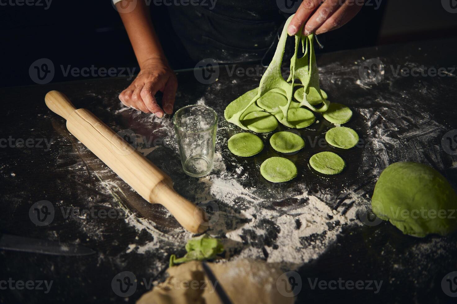 Chef Preparing Homemade Spinach Dough Dumplings in Rustic Setting photo