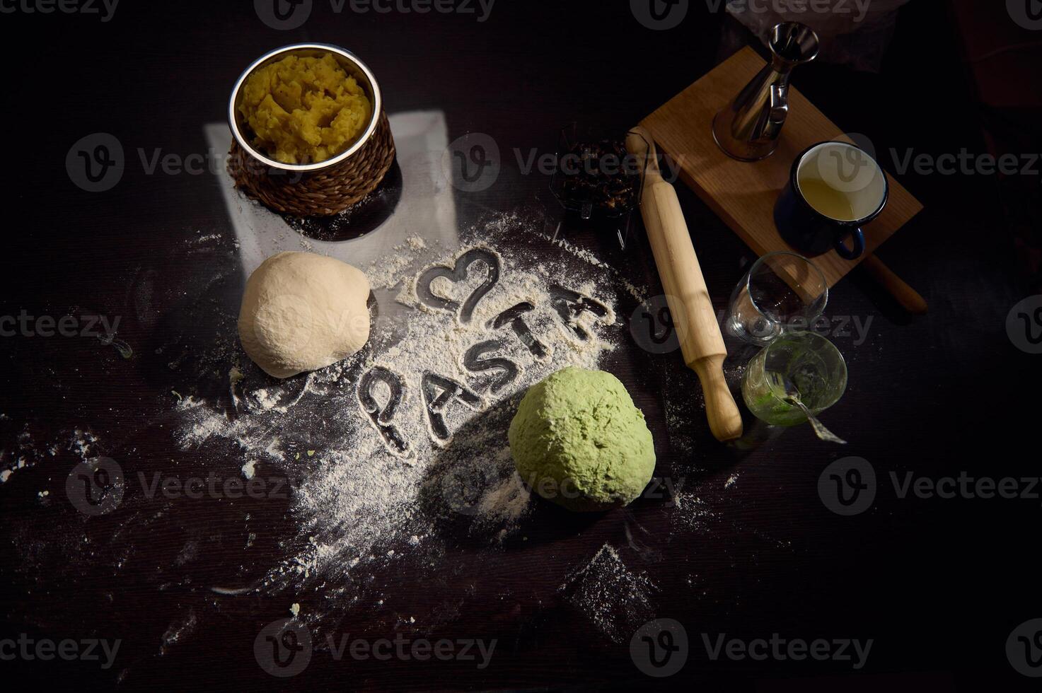 Creative Display of Pasta Making with Ingredients in a Culinary Art Setting photo