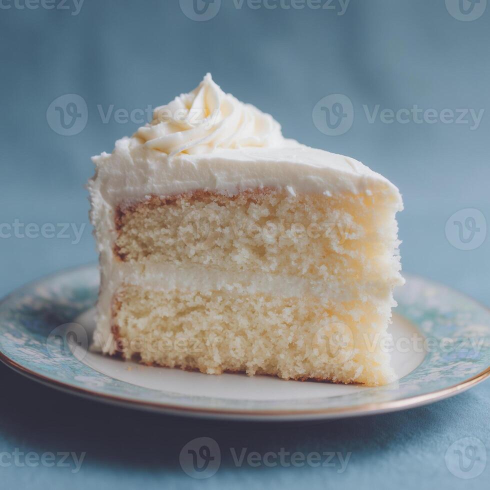 Slice of Layered White Cake with Frosting on Decorative Plate photo