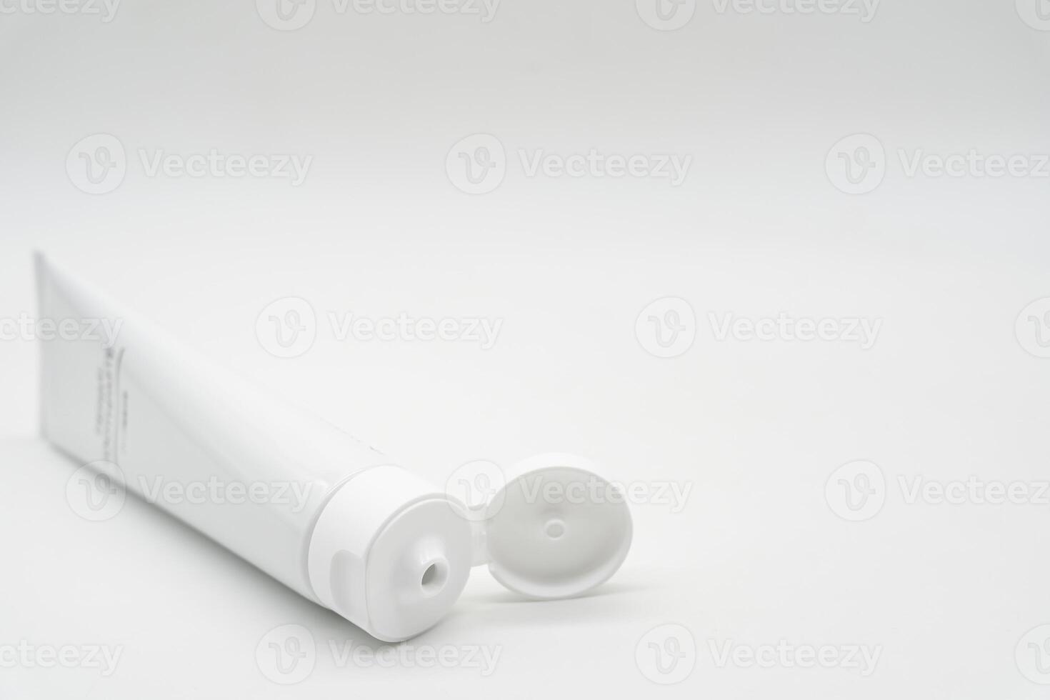 Minimal White Toothpaste Tube with Copy Space. White toothpaste tube with simple TOOTHPASTE text. dental care, oral hygiene, beauty, cosmetic products, and personal care branding. photo