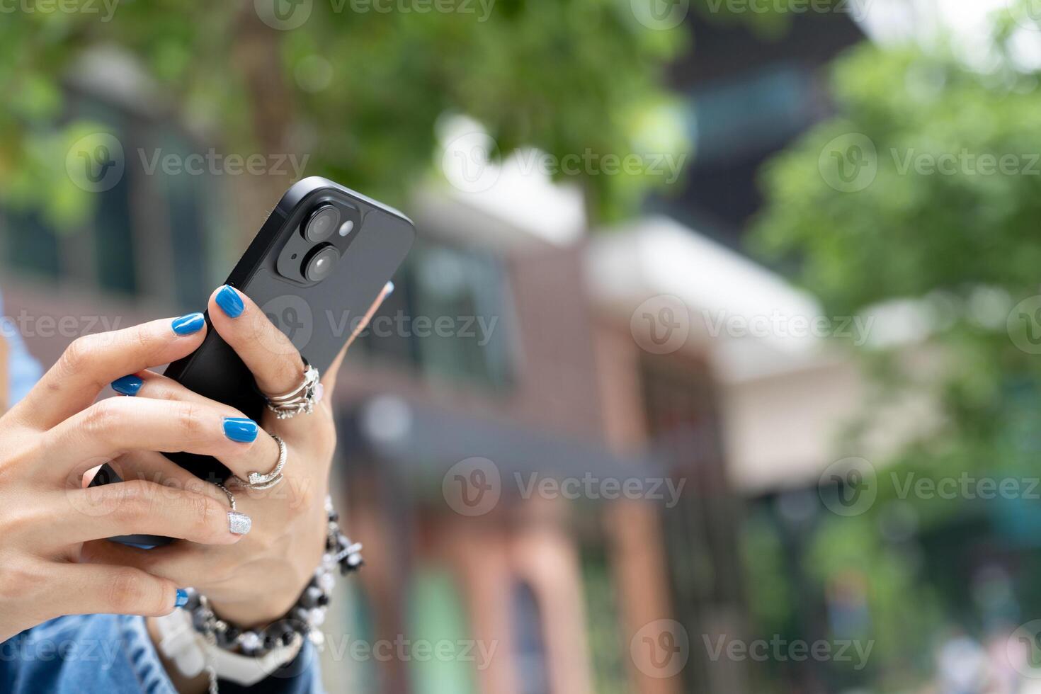 Woman Using Smartphone with Blank Screen Technology Concept. woman's hands holding and interacting with a smartphone that has a blank black screen. modern technology. Copy space. photo