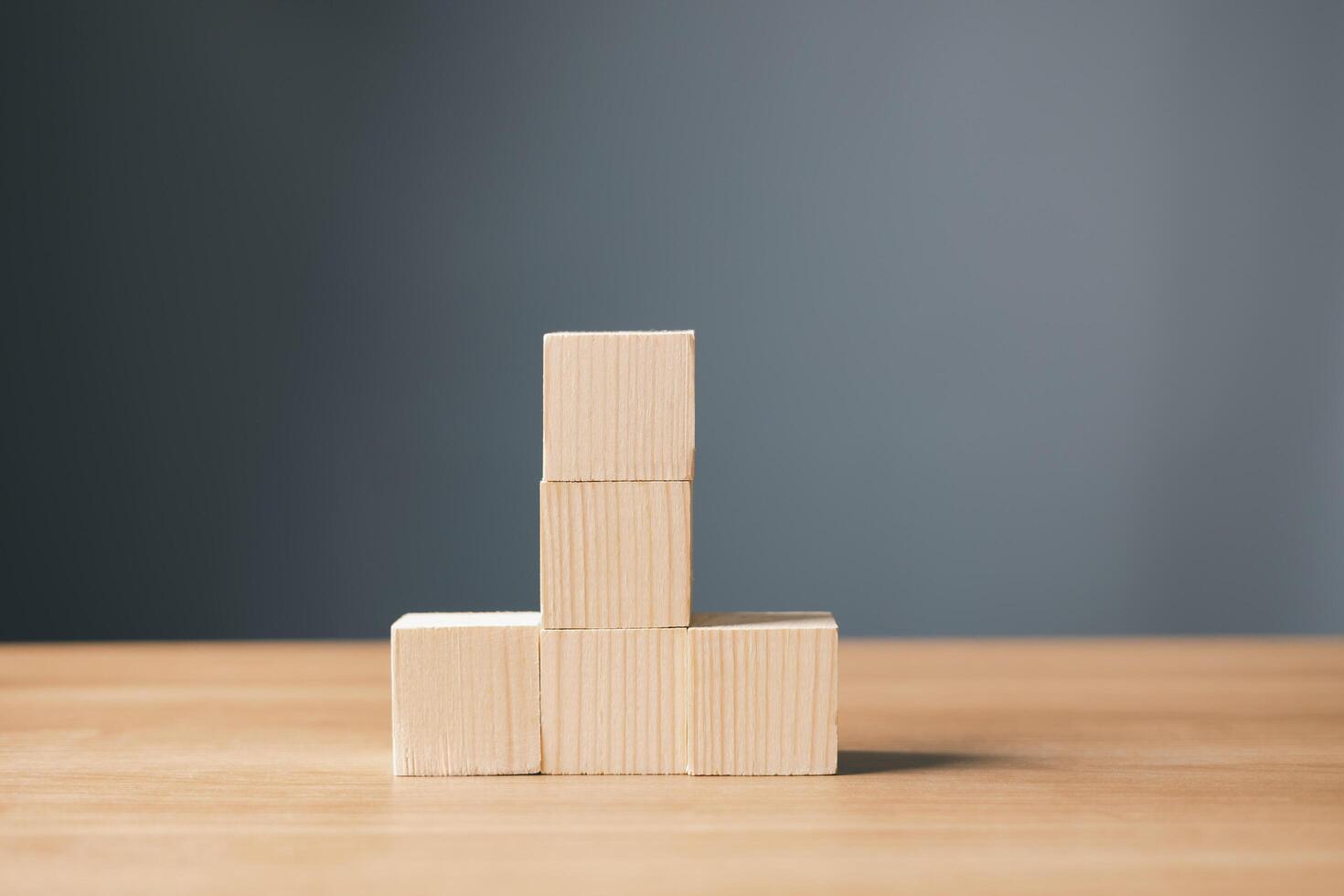 wood empty five blocks stack on table and gray background with copy space for text or symbols, development concept for growth success process. photo