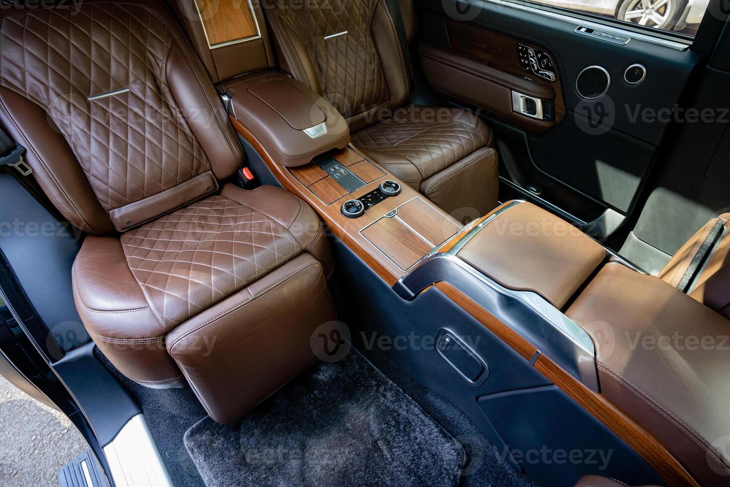 The luxurious leather interior of a highend vehicle is designed with attention to detail, featuring elegant wooden accents that enhance the aesthetic appeal and provide comfort to all passengers photo