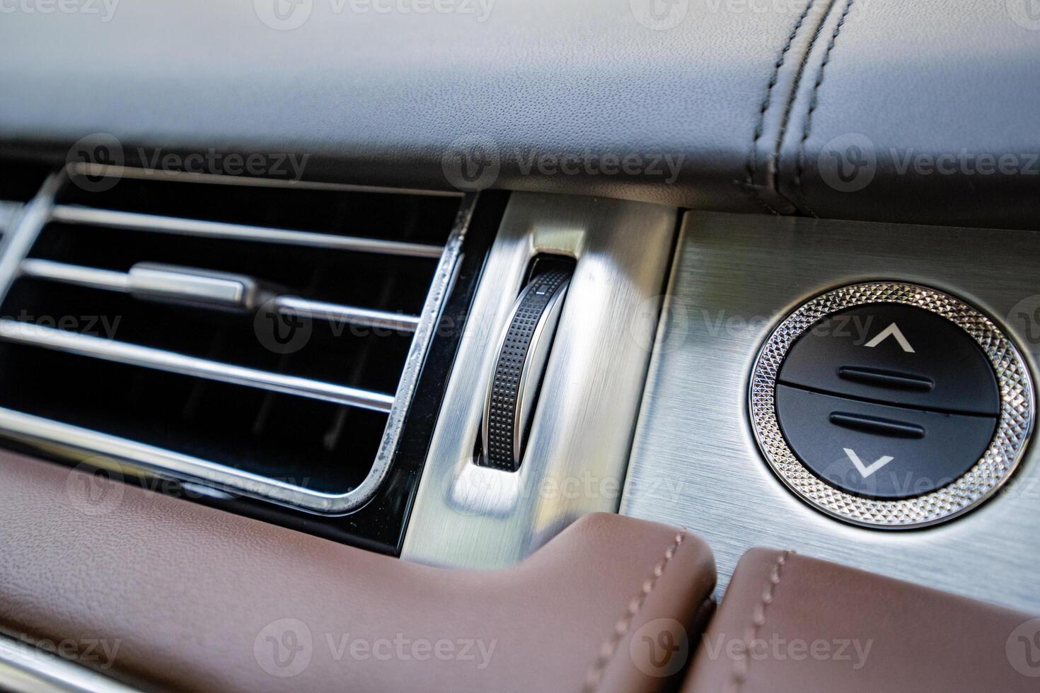 A Magnificent CloseUp View of the Luxurious Interior Features of a HighEnd Car, Highlighting the Sophisticated Air Vent Design and the Sleek Control Buttons That Enhance the Driving Experience photo