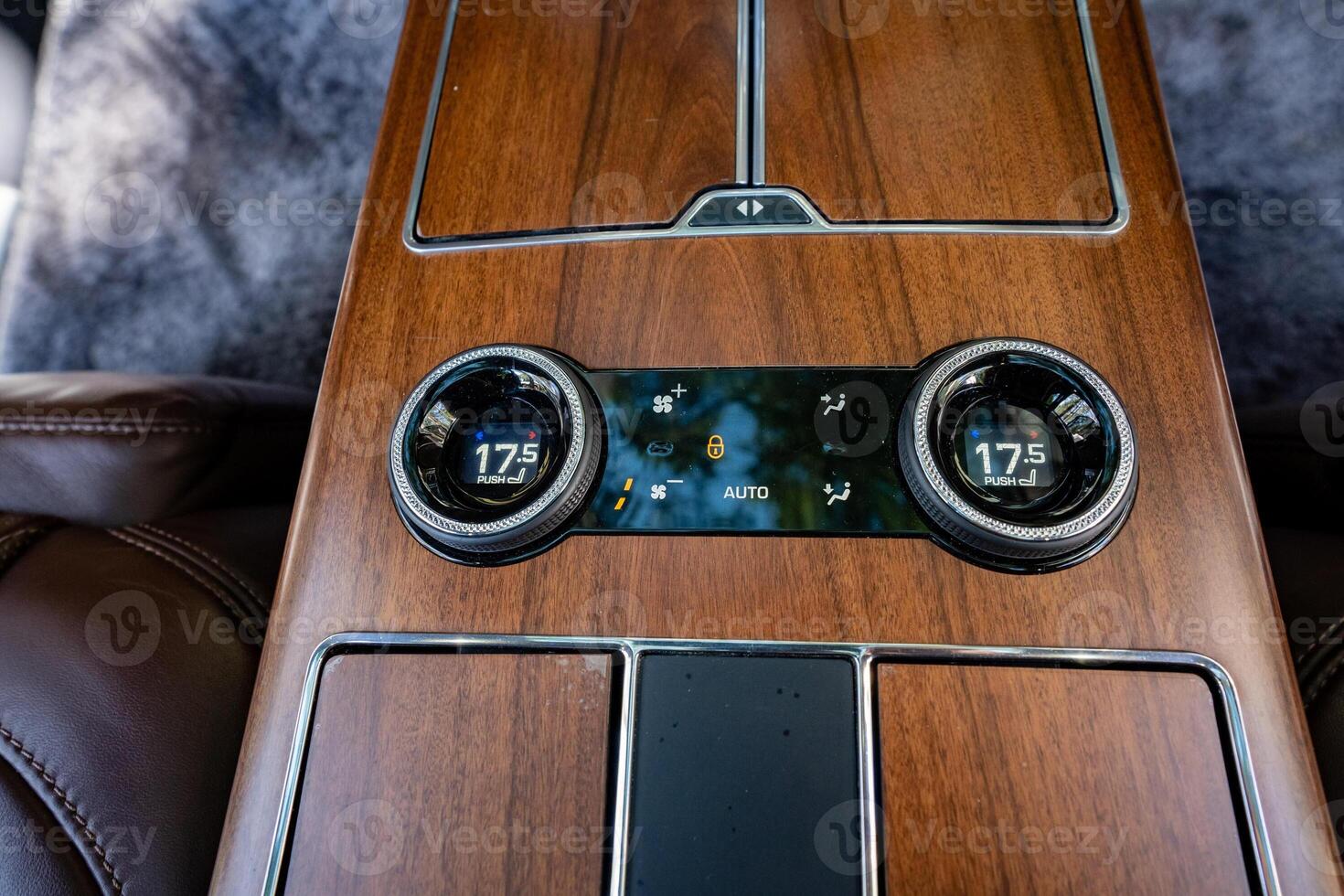 Luxury Vehicle Interior This stunning interior features a highend climate control system that ensures optimal comfort, beautifully complemented by an elegant wood finish that exudes sophistication photo