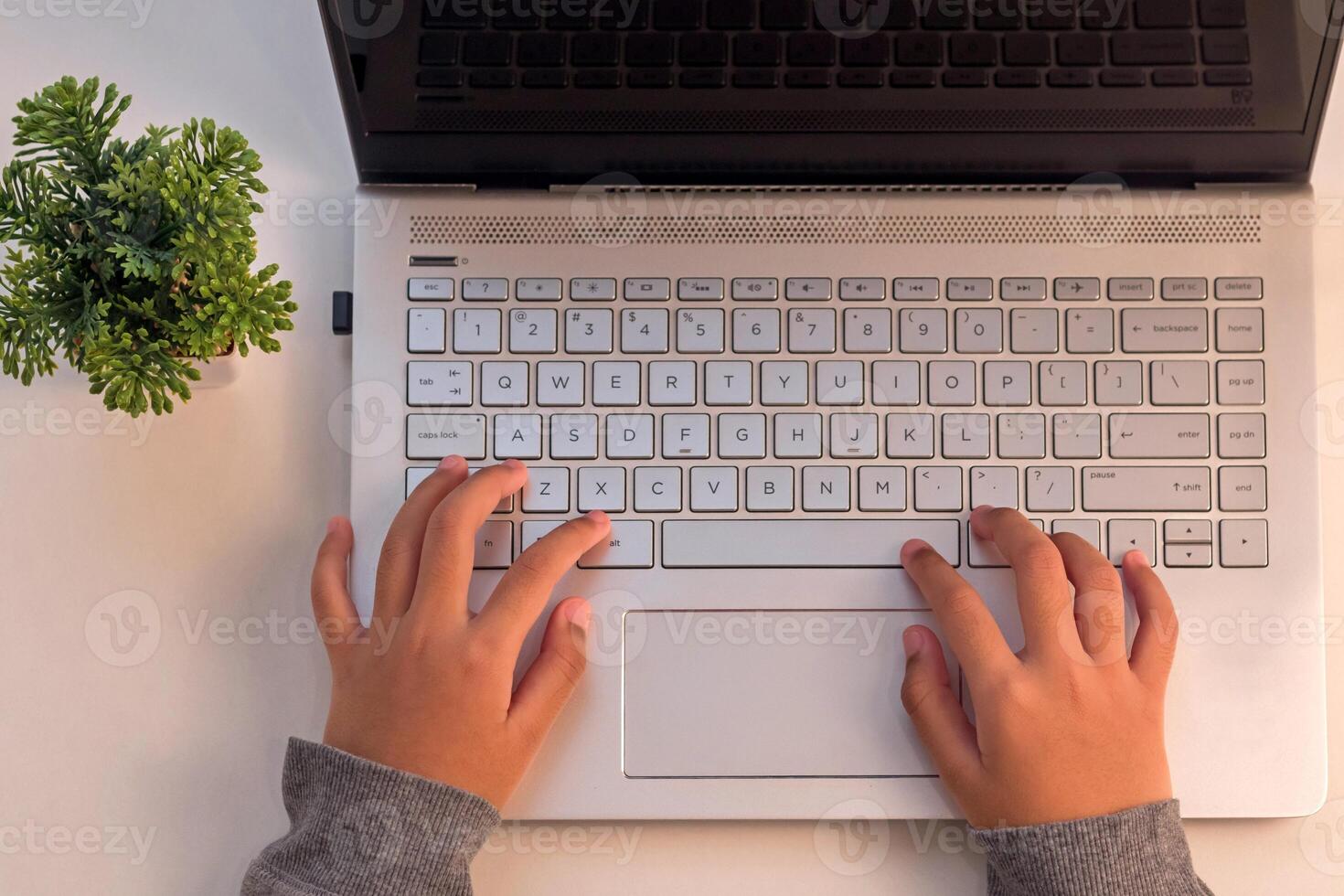 Top view of hands on a laptop keyboard. A student studying online on a laptop. photo