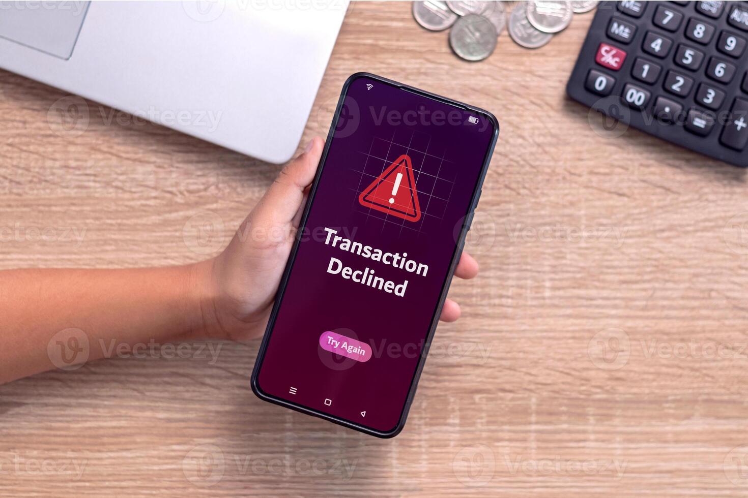 Hand holding smartphone with declined transaction notification on screen. Payment failed or declined. photo