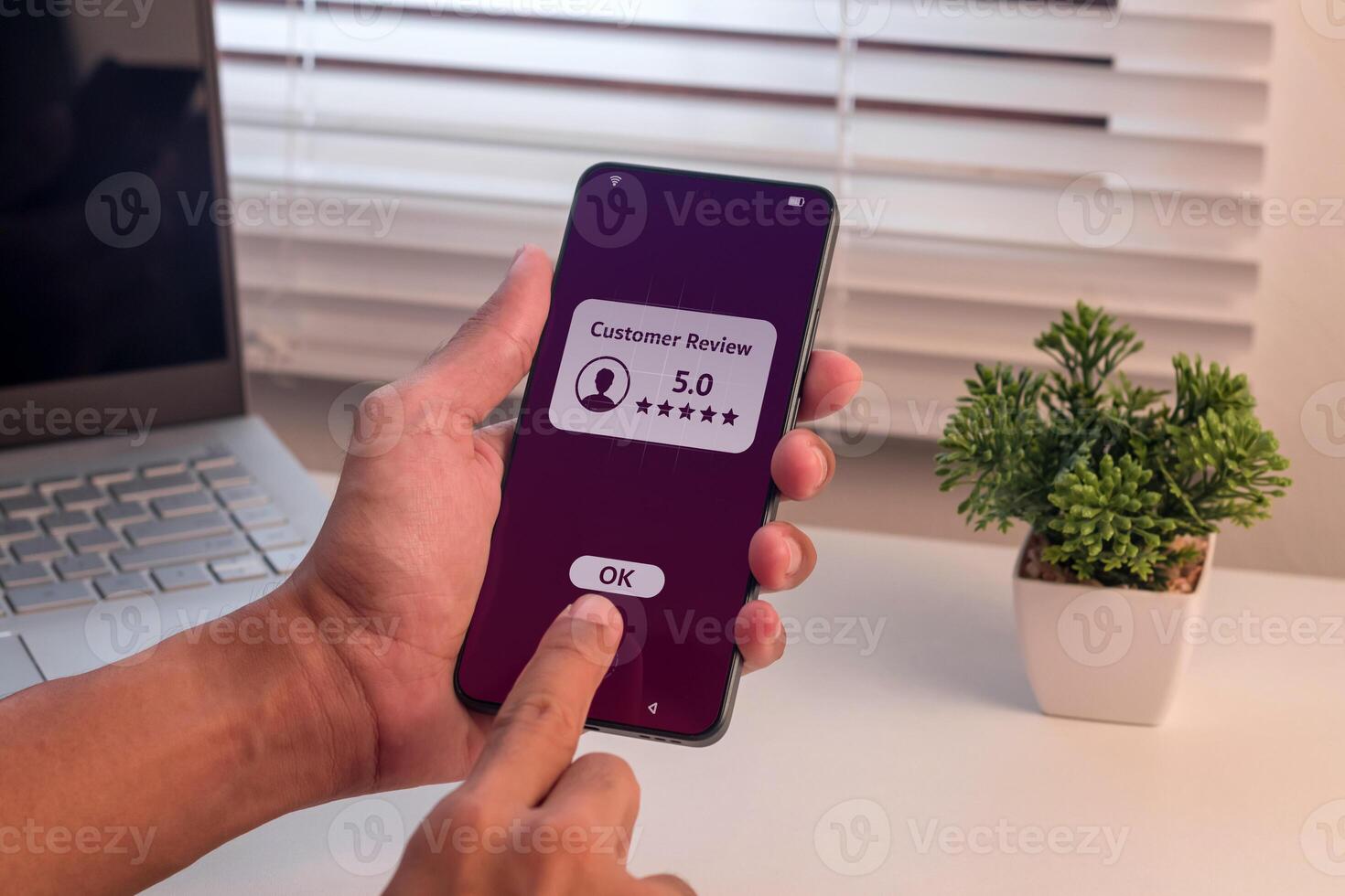 Man give a good rating to customer review on smartphone. Positive feedback or customer review satisfaction feedback concept. photo