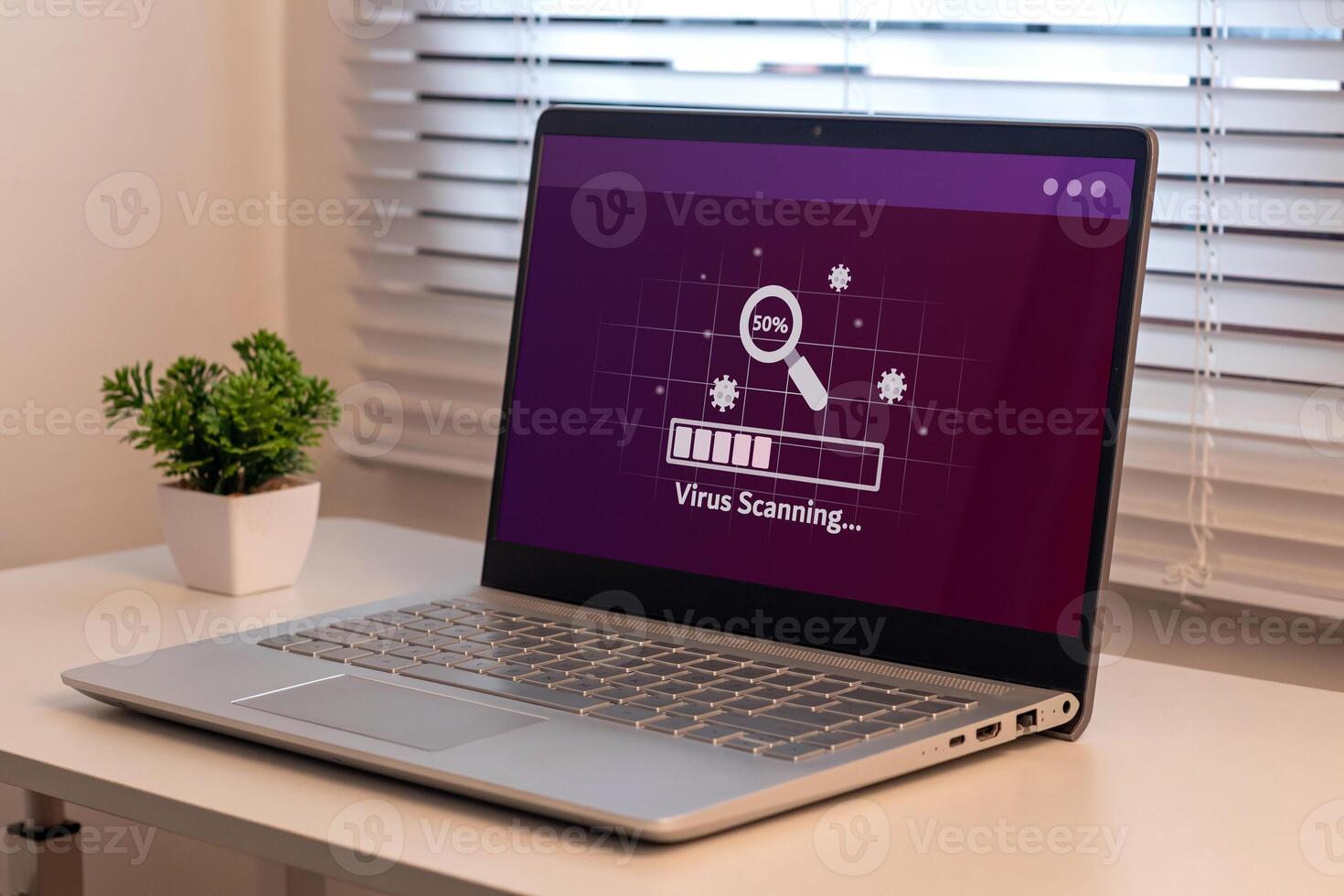 A laptop on the table with virus scanning process. Anti virus and bug protection technology concept. photo